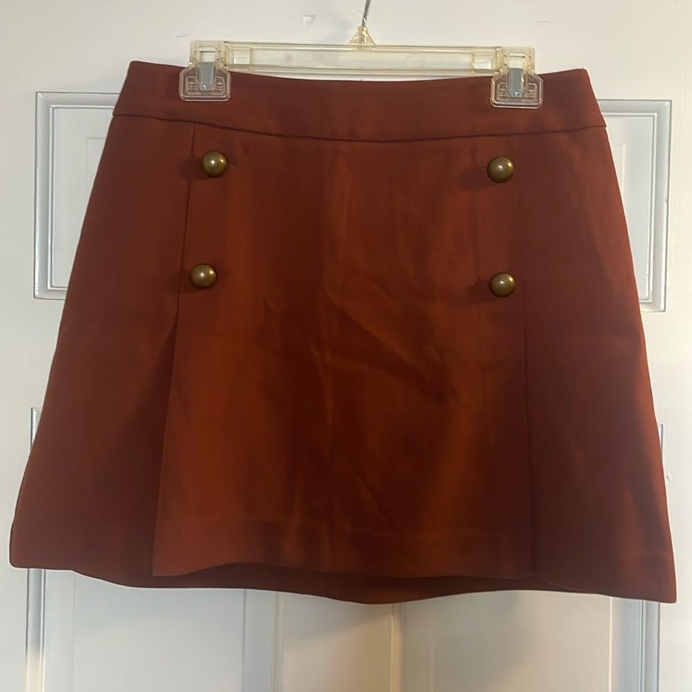 Burnt orange mini skirt with copper button details. Express size 10